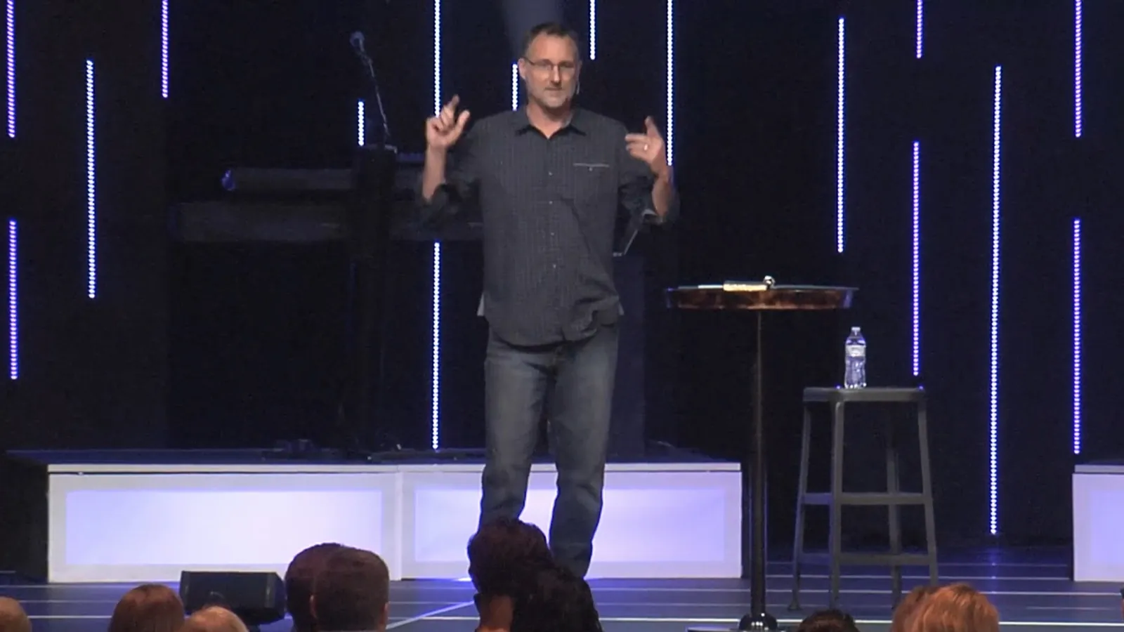 Mike Millett speaking on stage to a live conference audience