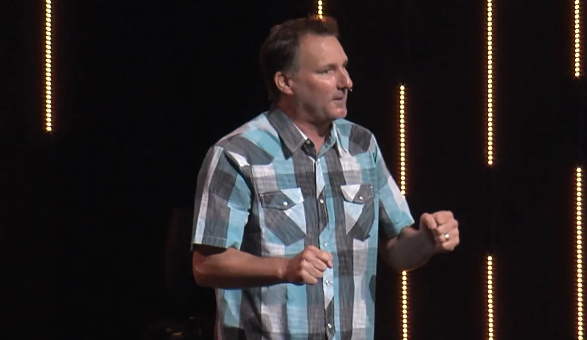 Mike Millett speaking on stage
